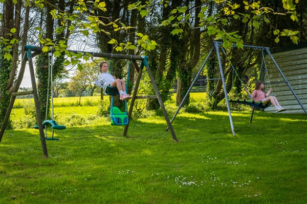 Children playing on the swings